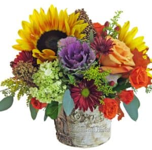 sunflowers, kale orange and peach roses in tin bucket