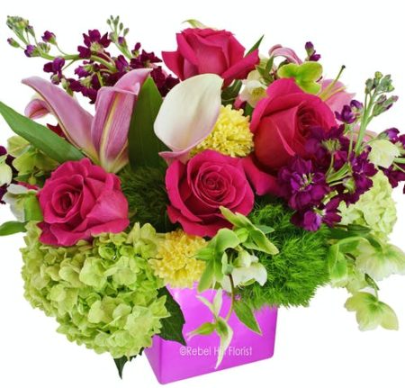 Green Hills Garden is a gorgeous colorful arrangement bursting with vibrant shades of pinks, greens and yellows that makes a wonderful gift anyone would treasure!