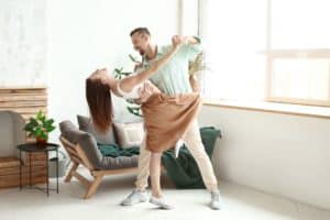 Young Couple Dancing in their living room ballroom style